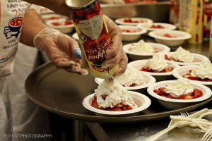 A volunteer preparing dessert at Soupline 2010 – credit to Red Bat Photography via Soupline web site